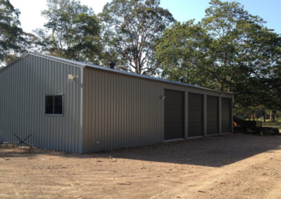 Farm shed, workshop with four roller doors and outdoor lights.