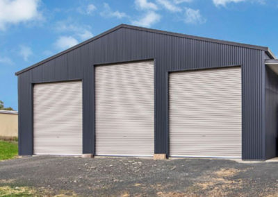 Workshop shed with three roller doors. One extra height.